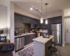 Polished Granite countertops, stainless steel appliances, islands, espresso cabinetry, plank flooring  